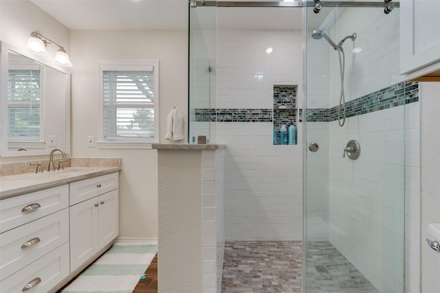 bathroom with walk in shower and vanity