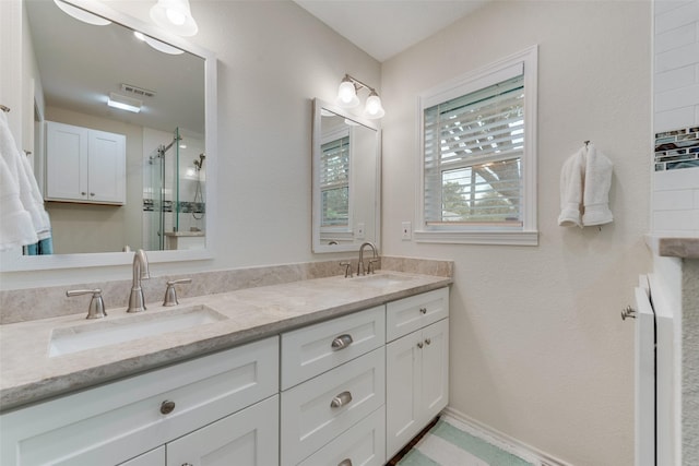 bathroom featuring vanity and an enclosed shower