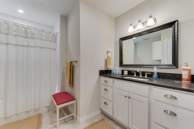 bathroom with tile patterned flooring and vanity