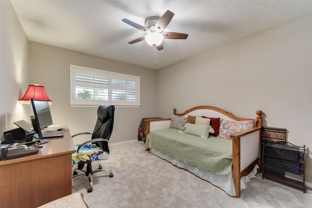 carpeted bedroom with a textured ceiling and ceiling fan