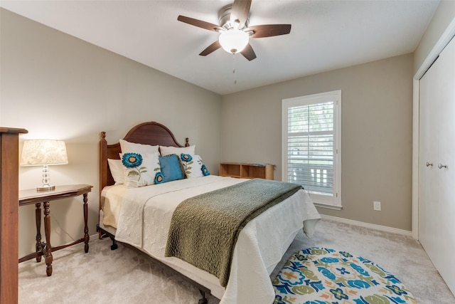 carpeted bedroom with ceiling fan and a closet