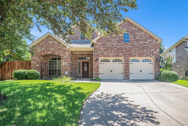 view of front property with a garage and a front lawn