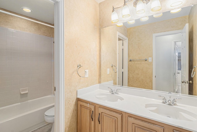 full bathroom with tiled shower / bath combo, toilet, and vanity