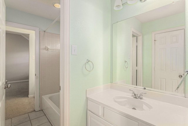 bathroom featuring tiled shower / bath, tile patterned floors, and vanity