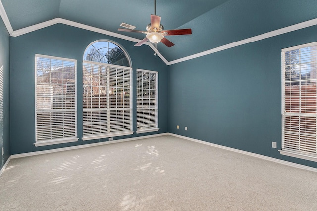 carpeted empty room with vaulted ceiling, ceiling fan, and ornamental molding