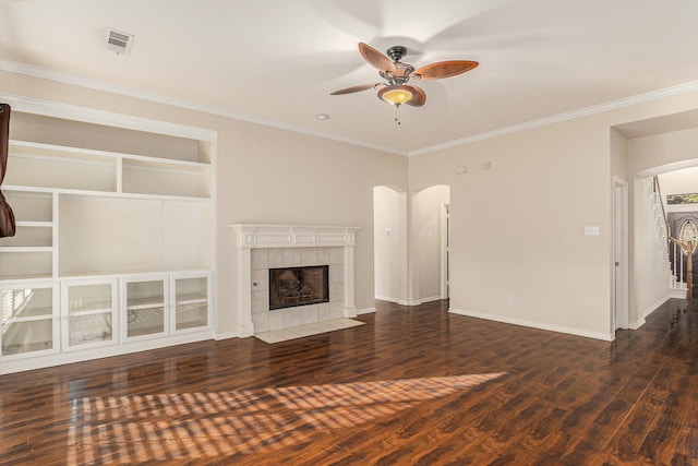 unfurnished living room featuring arched walkways, visible vents, ceiling fan, and wood finished floors