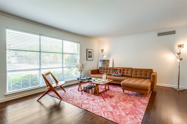 living room featuring hardwood / wood-style flooring and ornamental molding