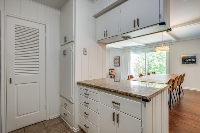 6131 Bandera Ave Unit A, Dallas, TX 75225 - kitchen with white cabinetry, dark wood-style flooring, a peninsula, and baseboards