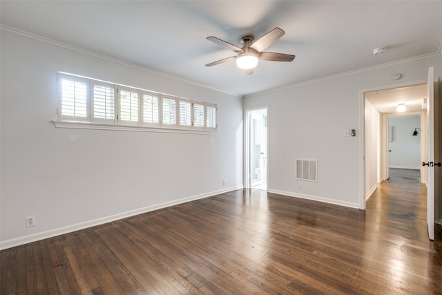 spare room with dark wood-type flooring, ornamental molding, a wealth of natural light, and ceiling fan