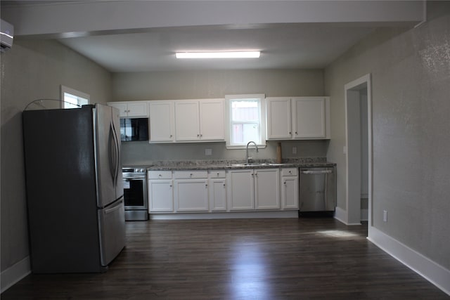 kitchen with white cabinetry, stainless steel appliances, sink, and dark hardwood / wood-style flooring