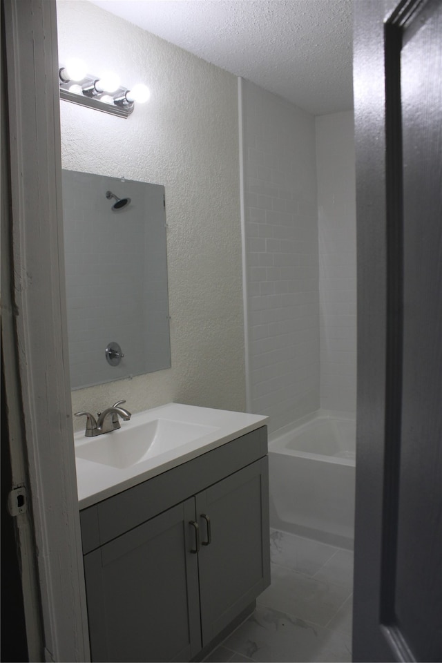 bathroom with independent shower and bath, a textured ceiling, and vanity