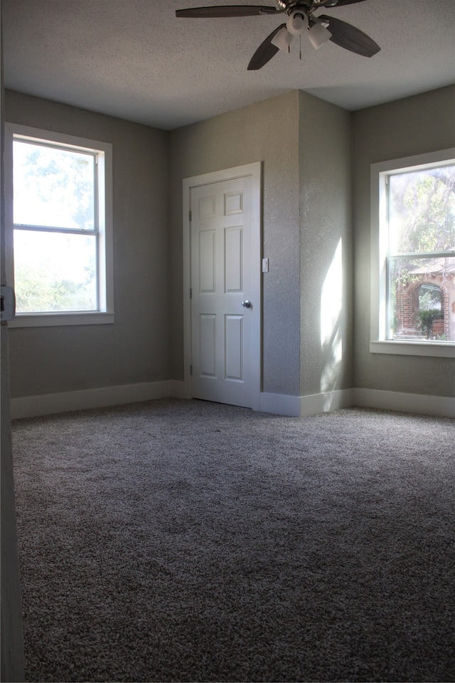 unfurnished bedroom featuring a textured ceiling, ceiling fan, and carpet flooring