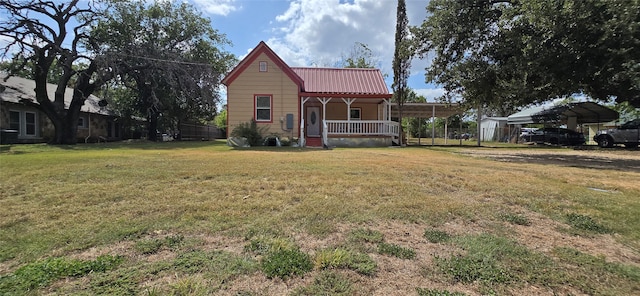 exterior space featuring a lawn, covered porch, and a carport