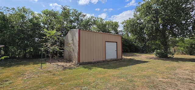 view of outdoor structure featuring a lawn