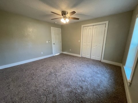 unfurnished bedroom with ceiling fan, a closet, and carpet floors