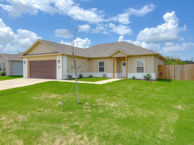 single story home featuring a garage and a front lawn