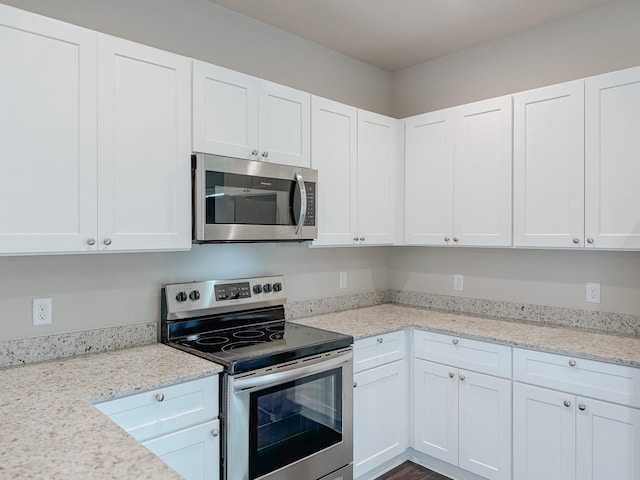 kitchen featuring stainless steel appliances and white cabinets