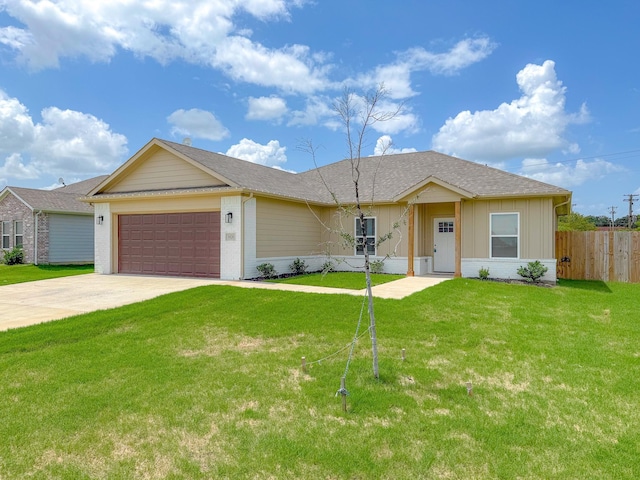 ranch-style house with a garage and a front lawn