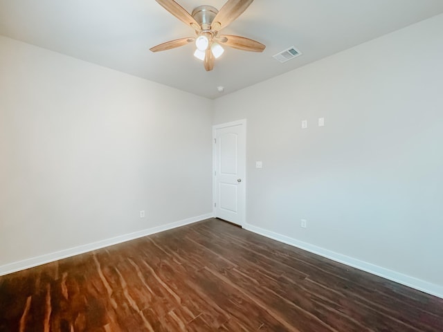 unfurnished room featuring dark wood-type flooring and ceiling fan