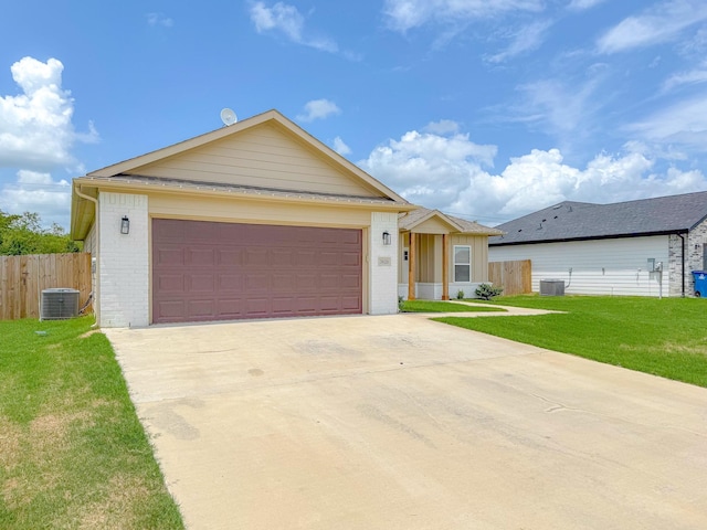 single story home with a garage, central AC, and a front yard