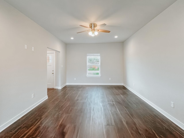 unfurnished room with dark hardwood / wood-style flooring and ceiling fan