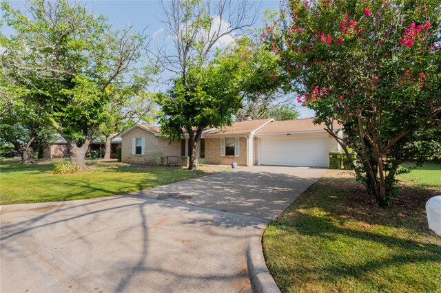 ranch-style house with a garage and a front lawn