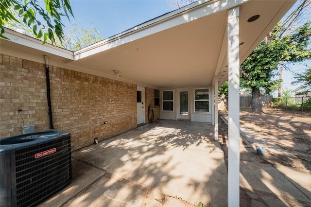1402 SE 22nd St, Mineral Wells, TX 76067 - view of patio featuring central air condition unit, fence, and a carport