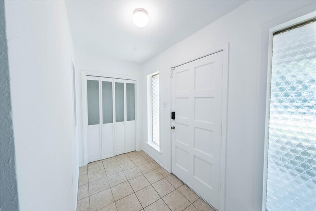 entryway with light tile patterned floors