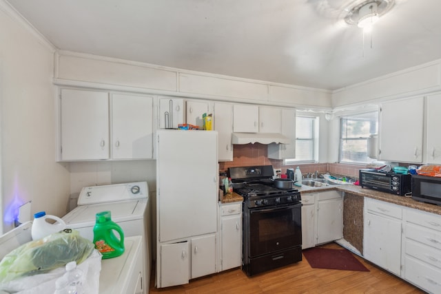 kitchen featuring white cabinetry, light hardwood / wood-style floors, and black gas stove