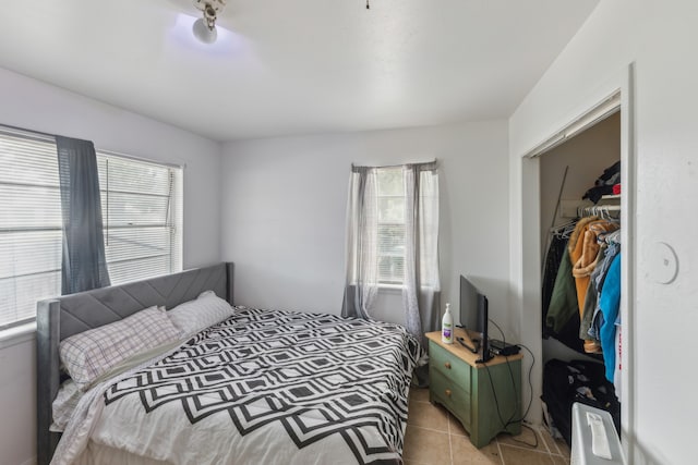 tiled bedroom with a closet