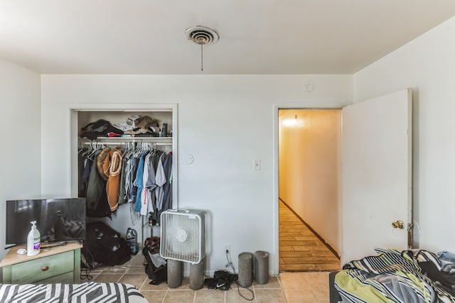 tiled bedroom featuring a closet