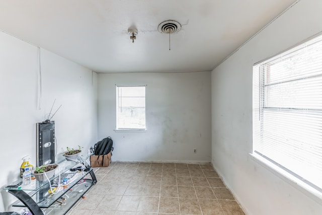 home office featuring light tile patterned flooring and a wealth of natural light