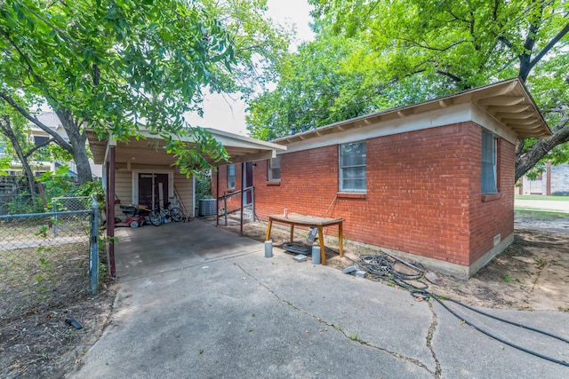 back of house featuring central AC unit