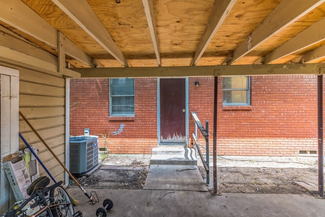 entrance to property with cooling unit and a patio area