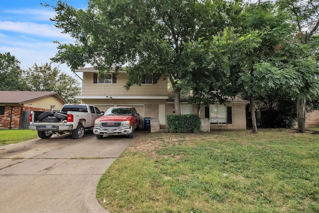 view of front of home featuring a garage and a front lawn