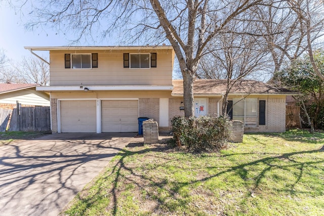 view of front facade featuring brick siding, fence, a front yard, driveway, and an attached garage