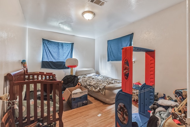 bedroom with wood-type flooring