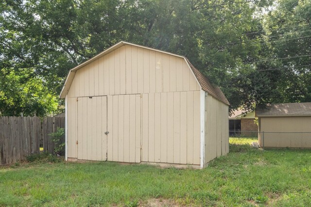 view of outbuilding featuring a lawn