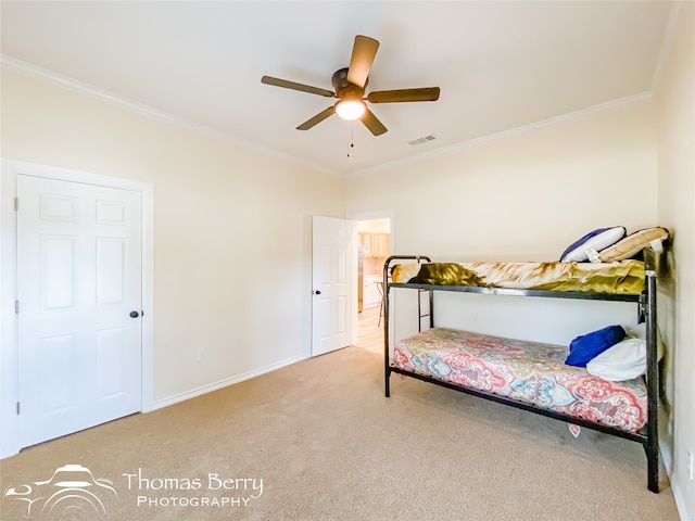 bedroom with light carpet, crown molding, and ceiling fan