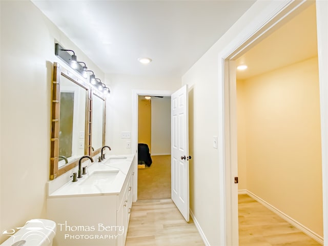 bathroom with french doors, wood-type flooring, and double sink vanity