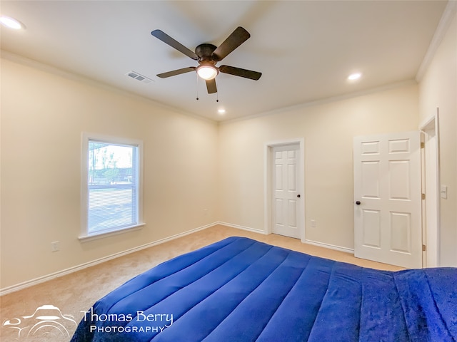 bedroom featuring light colored carpet, ceiling fan, and crown molding