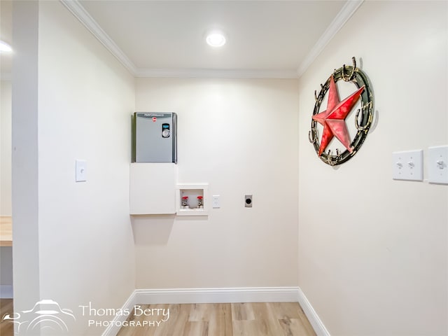 clothes washing area with electric dryer hookup, crown molding, washer hookup, and hardwood / wood-style floors