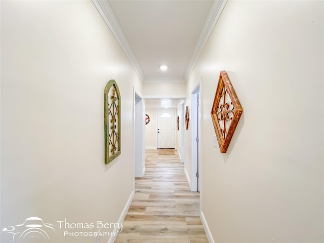 hallway featuring light hardwood / wood-style flooring and ornamental molding