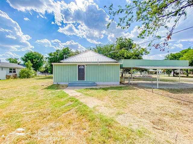 view of outdoor structure featuring a lawn