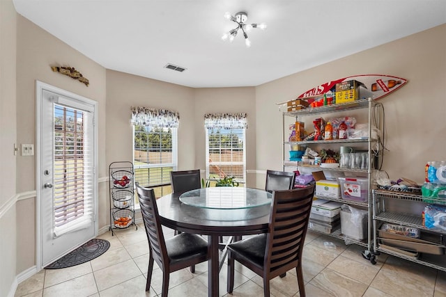 dining room with a healthy amount of sunlight and light tile patterned floors