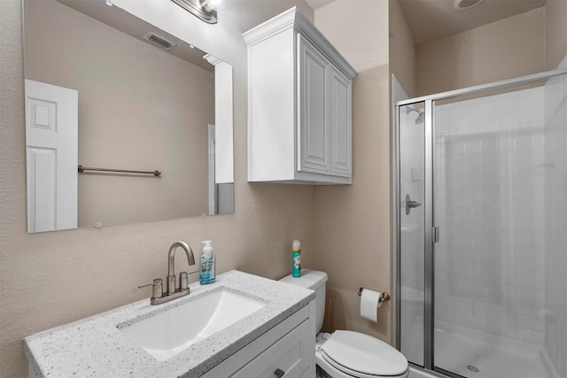 bathroom with vanity, toilet, and walk in shower