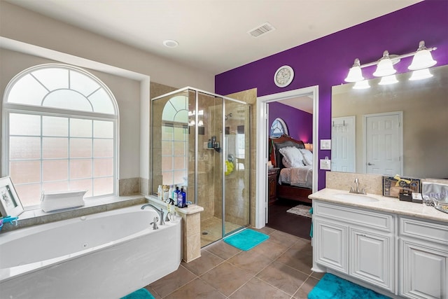 bathroom featuring shower with separate bathtub, tile patterned floors, and vanity