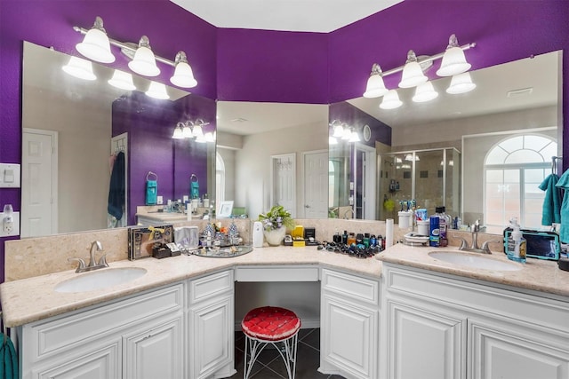 bathroom featuring tile patterned floors, a shower with shower door, and vanity