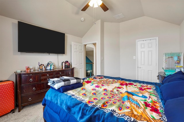 bedroom featuring light carpet, lofted ceiling, and ceiling fan