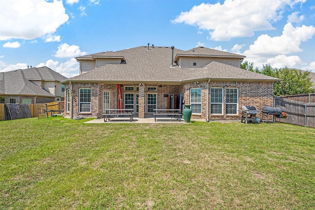 back of property featuring a lawn and a patio area